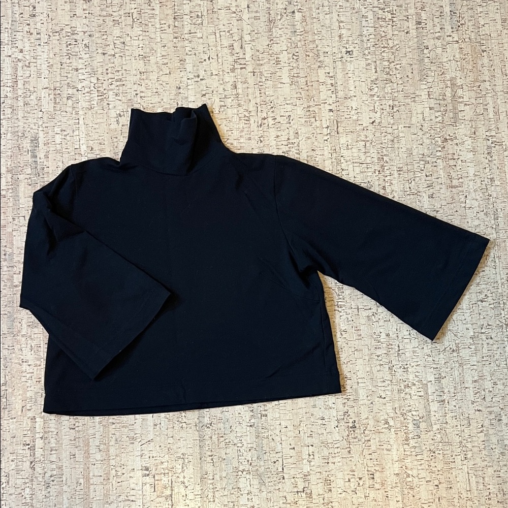 Bel Kazan Batna black turtleneck top with wide sleeves.